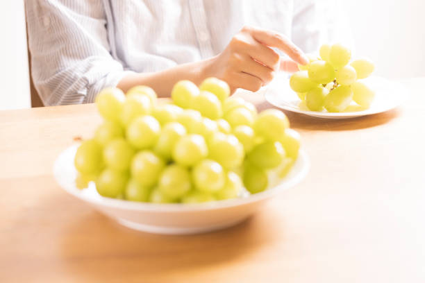 A bunch of muscat isolated on a green background.