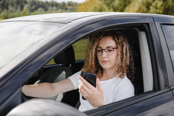 istock young woman in car 2182622078