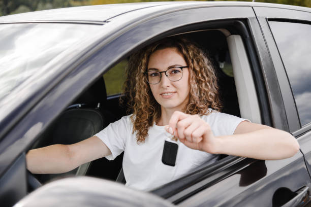 istock young woman in car 2182622086