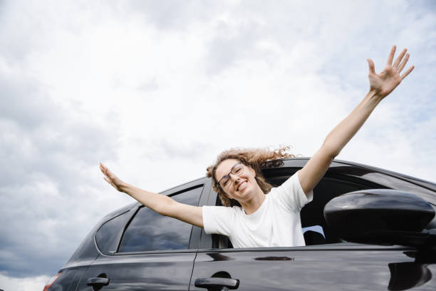 istock young woman in car 2182622101
