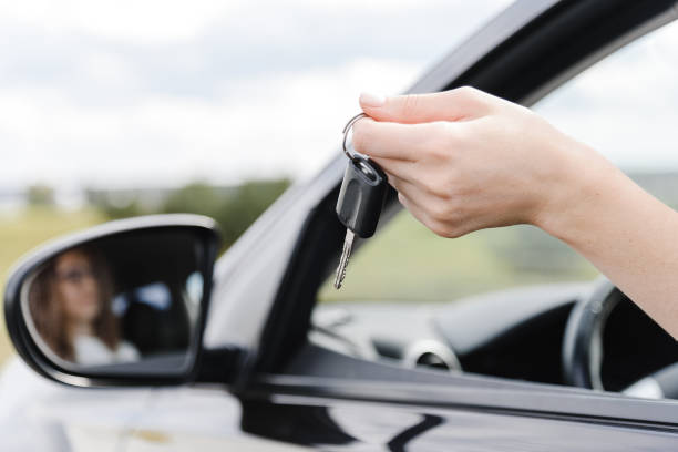 istock young woman in car 2182622106