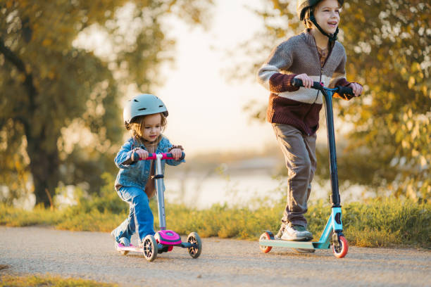istock A boy and his little sister ride a scooter 2182623107