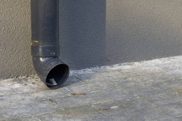 istock Rain runoff.New plastic drain pipe on a gray plastered wall 2182623249
