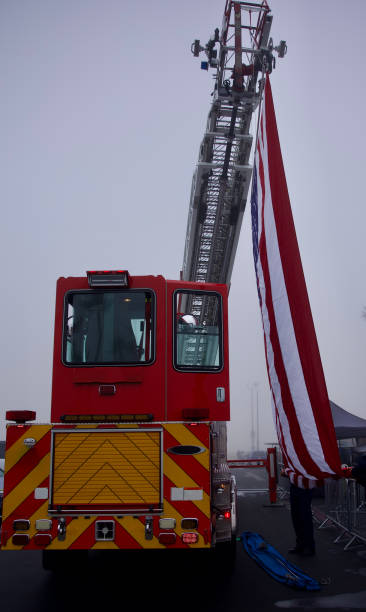 istock Fire truck hoisting the American flag 2182625165