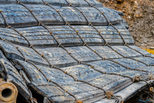 Pile of blasting mats at a construction site.