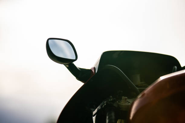 Navigate map on display smartphone on handle bar motorcycle with highway road view background