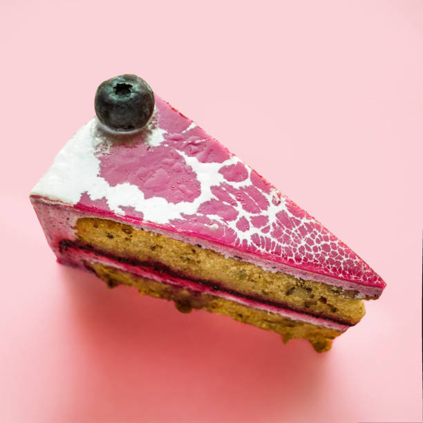 a piece of blueberry pie on a pink background. copy space.