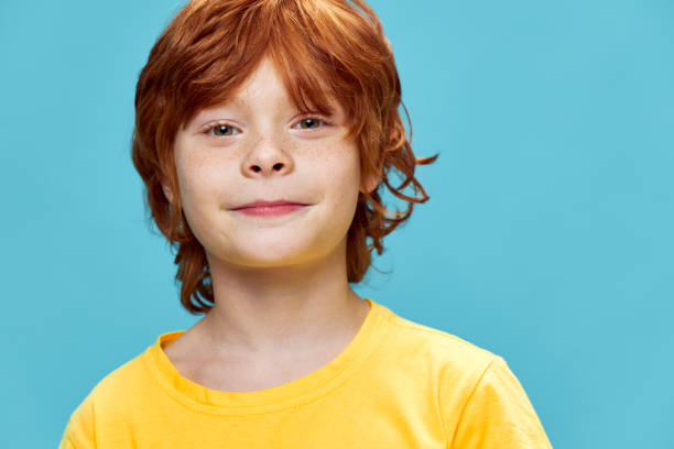 istock Beautiful red-haired boy smiling on an isolated background 2182632669