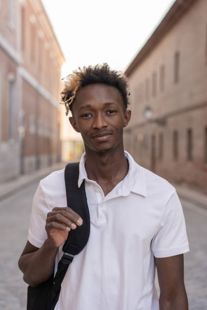 istock Confident student walking in city street with backpack 2182633598