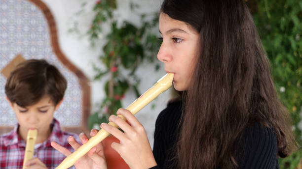 istock Children playing flute in home patio 2182638683