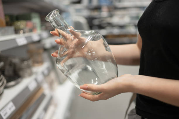 istock Young Girl In Store Choosing Vase 2182638904