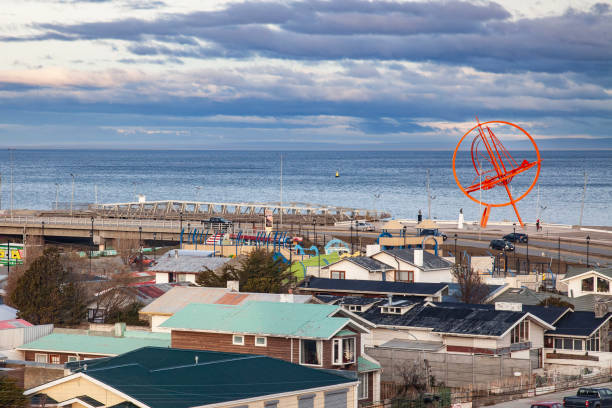 Elevated view over the rooftops of part of Punta Arenas, Chile, towards the Magellan Strait and the statue commomorating the 500th anniversray of Fernando Magellan discovering the Straits - Circunnavegación  (Circumnavigation), 2020 by Francisco Gazitua.