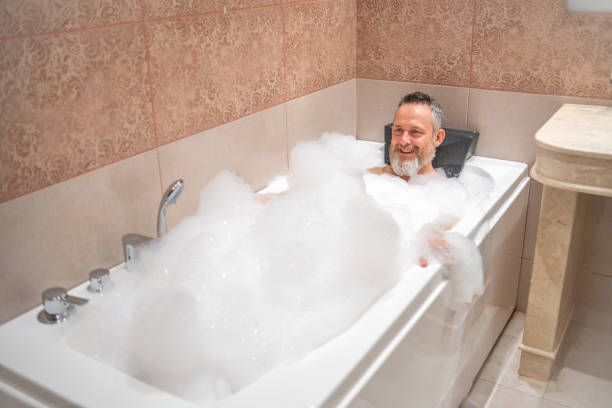 istock A mature man with a white beard is enjoying a bath in a bathroom. 2182641930