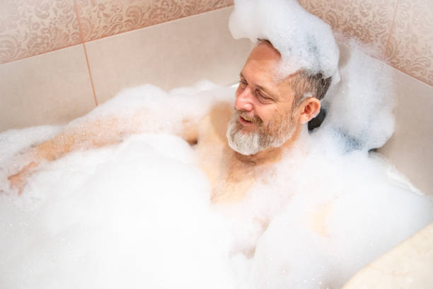 istock A mature man with a white beard is enjoying a bath in a bathroom. 2182641992