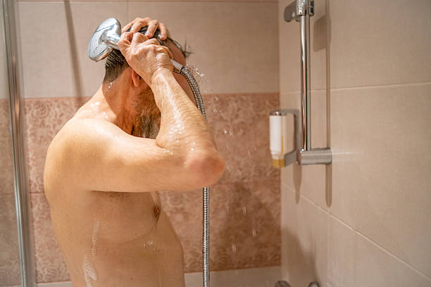 istock An unrecognizable man takes a shower. 2182642082