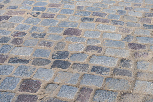 istock gray cobbled road from concrete pavers 2182645531