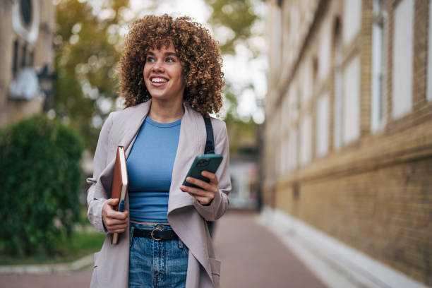 istock A cheerful female student standing outside the university. 2182649072