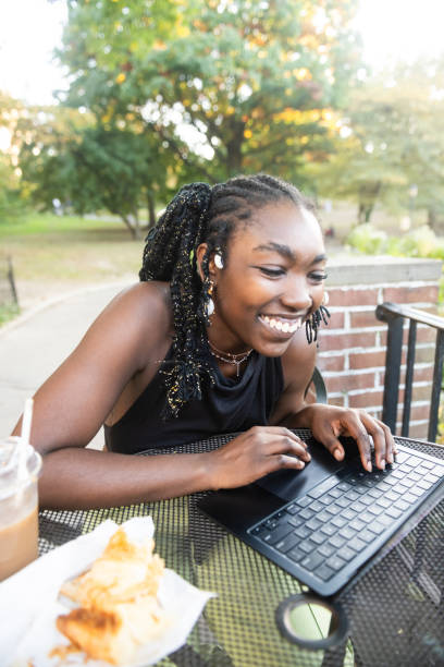istock Young Black Woman Laughing While Online Outdoors in NYC 2182649764