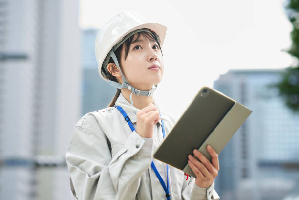 istock A young woman wearing work clothes and a helmet 2182650631