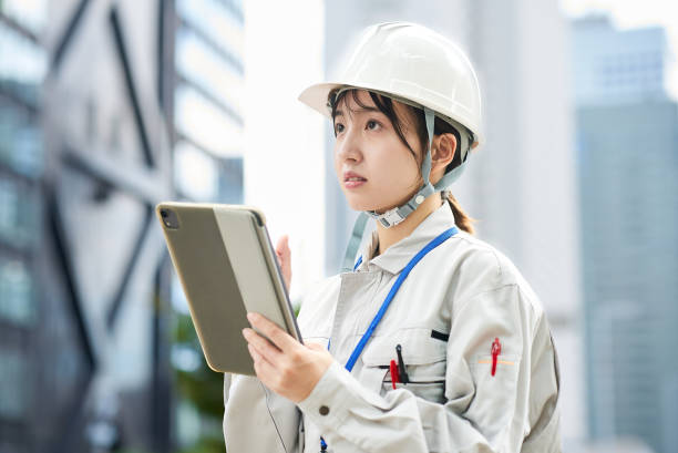 istock A young woman wearing work clothes and a helmet 2182650662