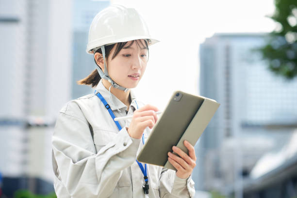 istock A young woman wearing work clothes and a helmet 2182650698