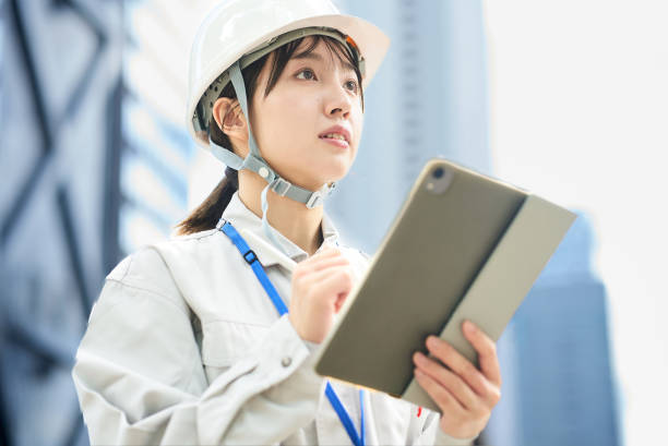 istock A young woman wearing work clothes and a helmet 2182650772
