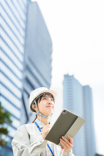 istock A young woman wearing work clothes and a helmet 2182650789