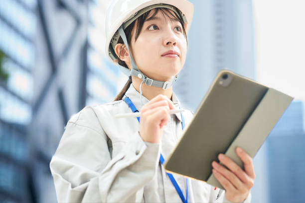 istock A young woman wearing work clothes and a helmet 2182650804