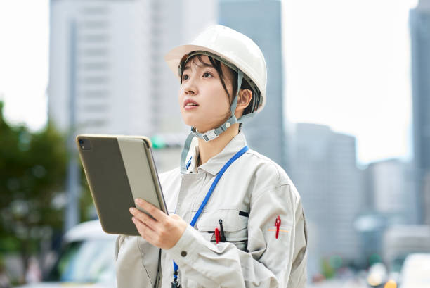 istock A young woman wearing work clothes and a helmet 2182650866