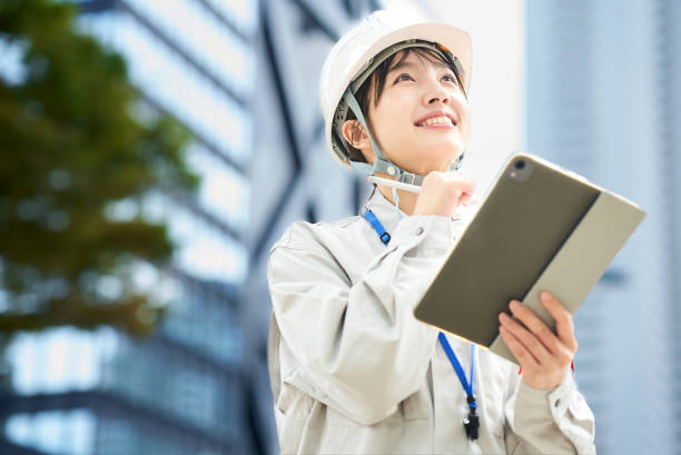 istock A young woman wearing work clothes and a helmet 2182650900
