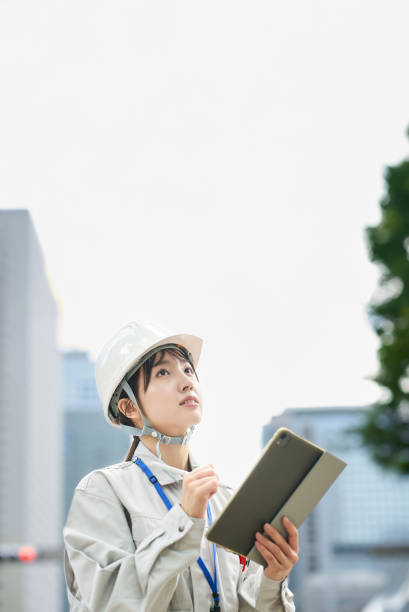 istock A young woman wearing work clothes and a helmet 2182651025