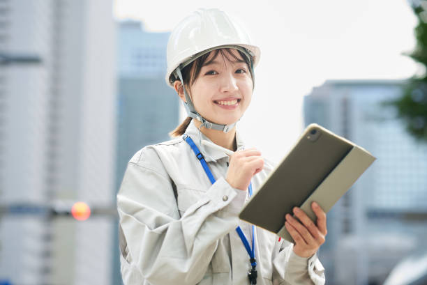 istock A young woman wearing work clothes and a helmet 2182651039
