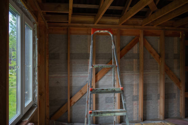 a metal staircase inside a frame house under construction. the concept of construction and renovation. natural light.