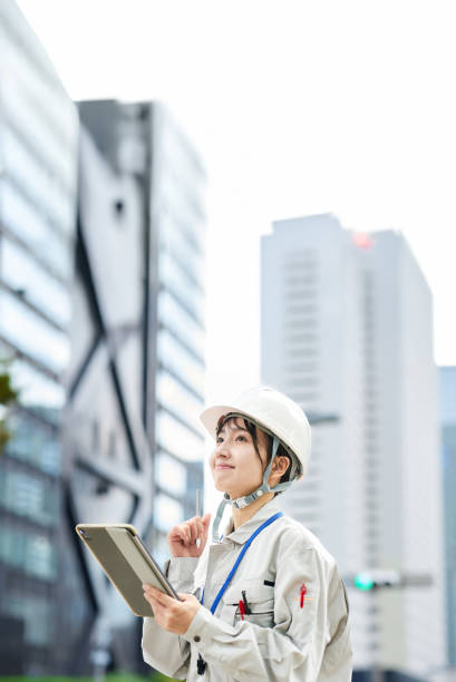 istock A young woman wearing work clothes and a helmet 2182651085