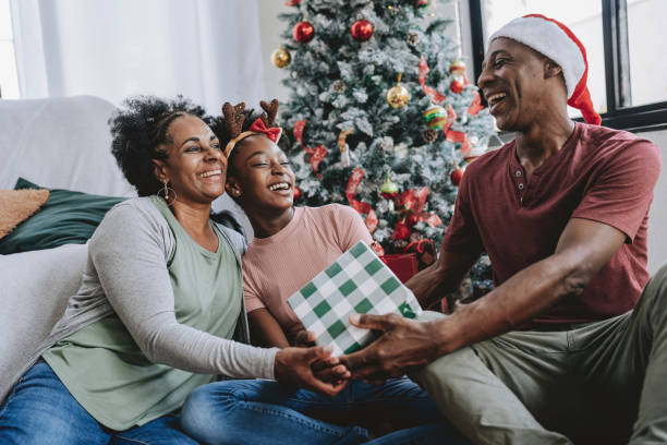 istock Father and mother Christmas gift for daughter 2182653085