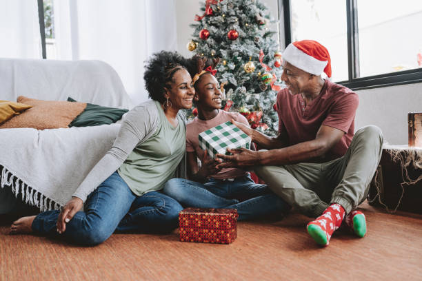 istock Father and mother Christmas gift for daughter 2182653132