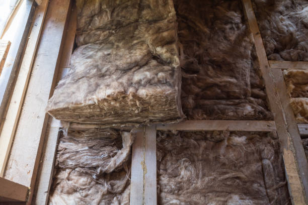 istock laying insulation on the floor in a frame house under construction. 2182653221