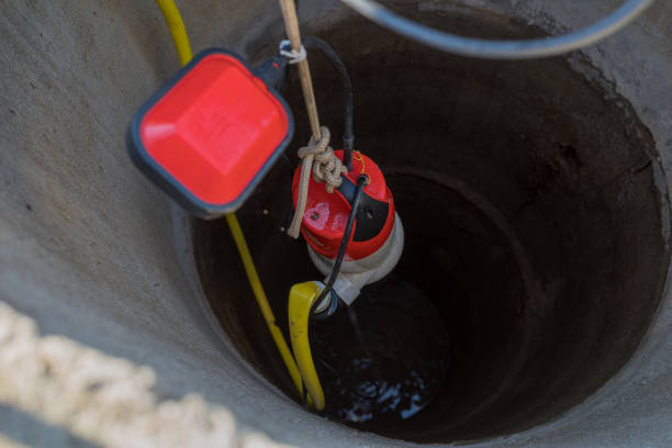 istock lifting a pump from a deep well to pump water. 2182653396