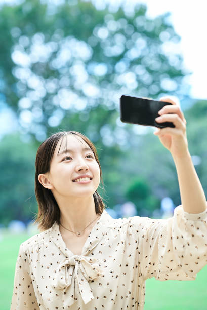istock Young woman taking a picture with a smartphone 2182653984