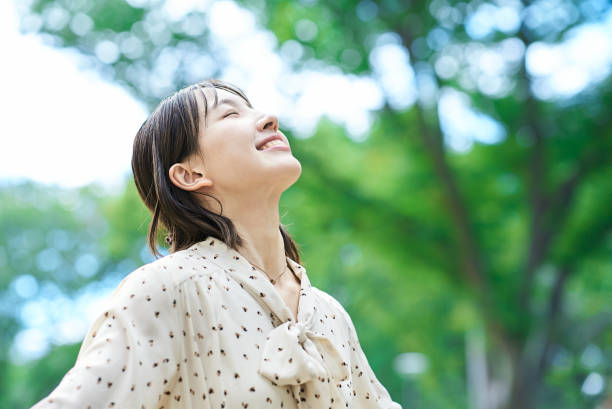 istock a young woman relaxing in green space 2182654685
