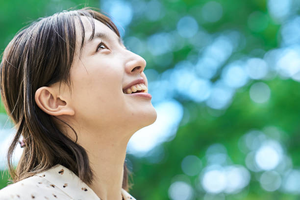 istock a young woman relaxing in green space 2182654741