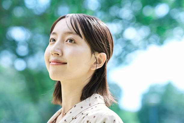 istock a young woman relaxing in green space 2182654884