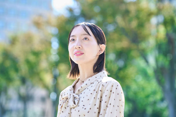 istock a young woman relaxing in green space 2182655049