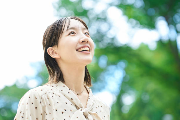 istock a young woman relaxing in green space 2182655176