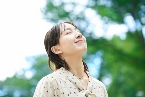 istock a young woman relaxing in green space 2182655261
