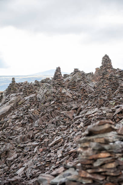 istock Stacked stone cairns under cloudy sky symbolize tranquility 2182655468