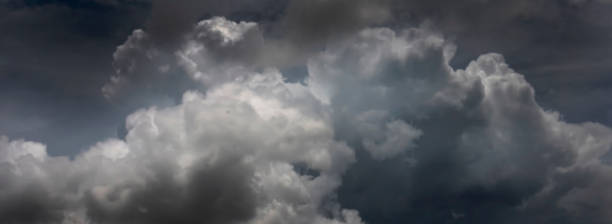 istock Banner Dramatic dark storm clouds black sky background. Dark thunderstorm clouds rainny season. Panorama Meteorology danger windstorm disasters climate. Dark cloudscape storm cloud with copy space. 2182656912