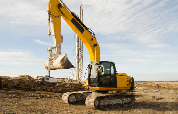 istock Building activity on contruction site.Drilling machine.Wind turbine construction.
Excavator and other construction equipment. 2182656995
