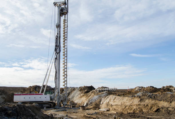 istock Building activity on contruction site.Drilling machine.Wind turbine construction.
Excavator and other construction equipment. 2182656998