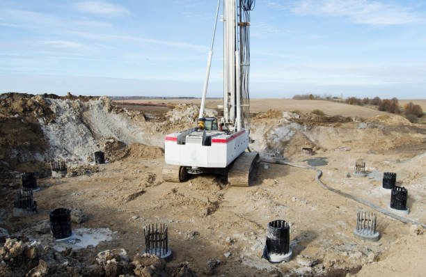 istock Building activity on contruction site.Drilling machine.Wind turbine construction.
Excavator and other construction equipment. 2182656999